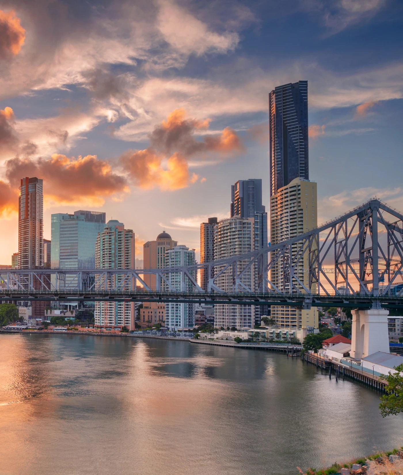 Brisbane city skyline and the Story Bridge at sunset over the river