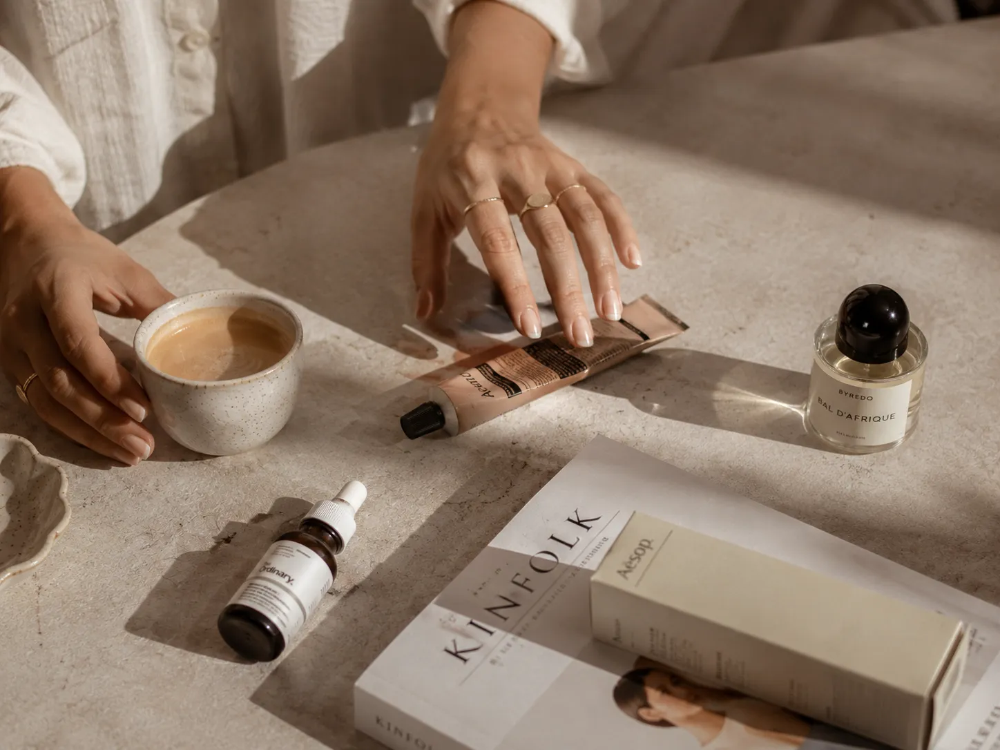 Creator styling skincare products and a magazine in a flat-lay content shoot